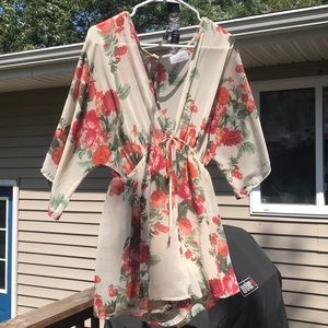 Red, orange, and green floral print romper